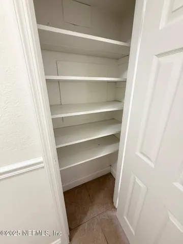 a white bath tub sitting next to a white sink and a mirror