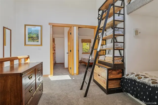 a bedroom with bunk bed and a window