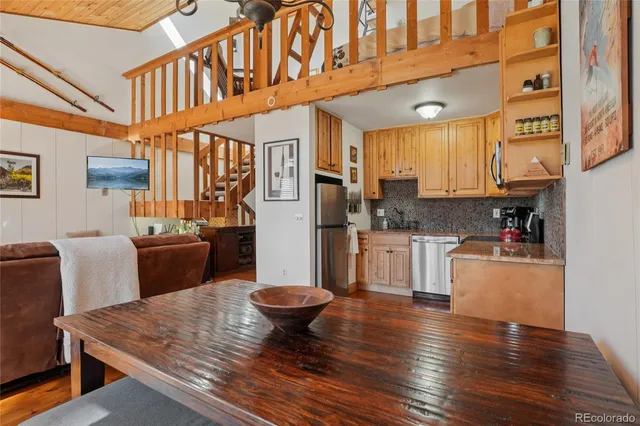 a open kitchen with stainless steel appliances granite countertop a stove and a refrigerator