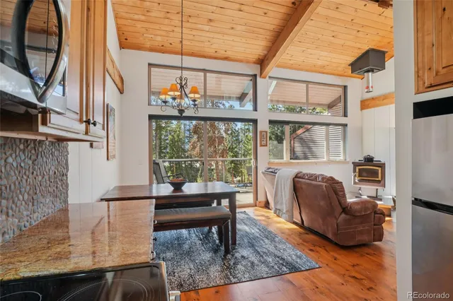 a living room with furniture a rug and a large window