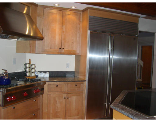 18 Stinson Road Andover, MA 01810 - Photo 10 of 15 a kitchen with a refrigerator and a stove top oven