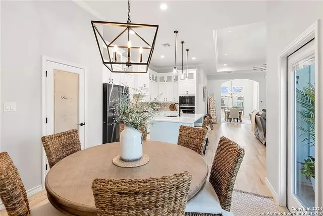 a dining room with furniture a rug and a chandelier