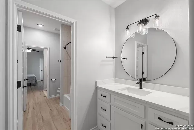 a bathroom with a sink a mirror and a shower