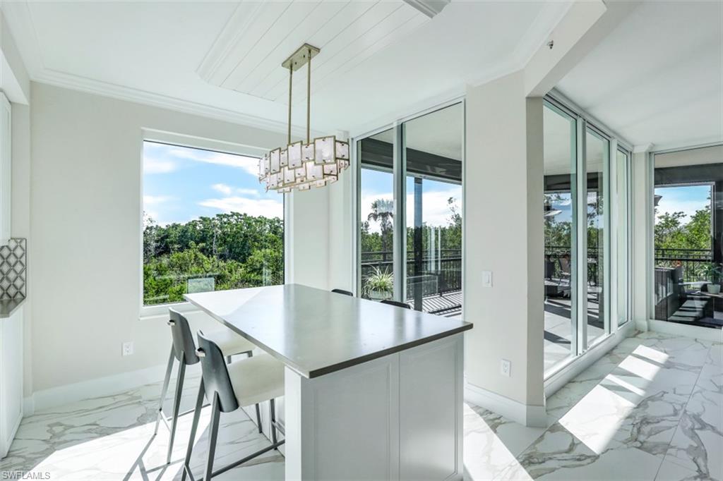 425 Cove Tower Drive, Unit 301 Naples, FL 34110 - Photo 16 of 43 a view of a dining room and window