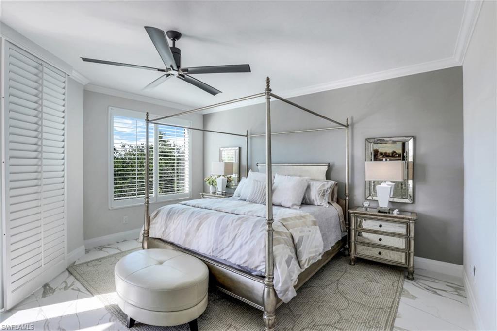 425 Cove Tower Drive, Unit 301 Naples, FL 34110 - Photo 18 of 43 a bedroom with a bed and window