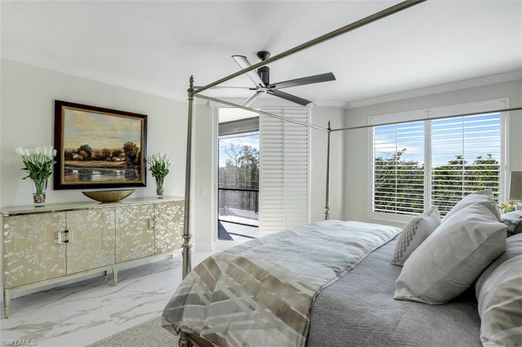 425 Cove Tower Drive, Unit 301 Naples, FL 34110 - Photo 19 of 43 a bedroom with a bed and wooden floor