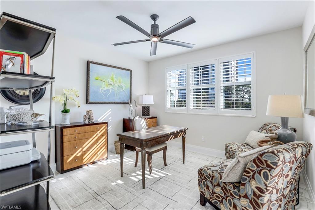 425 Cove Tower Drive, Unit 301 Naples, FL 34110 - Photo 26 of 43 a living room with furniture and a window