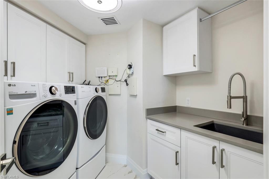 425 Cove Tower Drive, Unit 301 Naples, FL 34110 - Photo 27 of 43 a utility room with sink dryer and washer