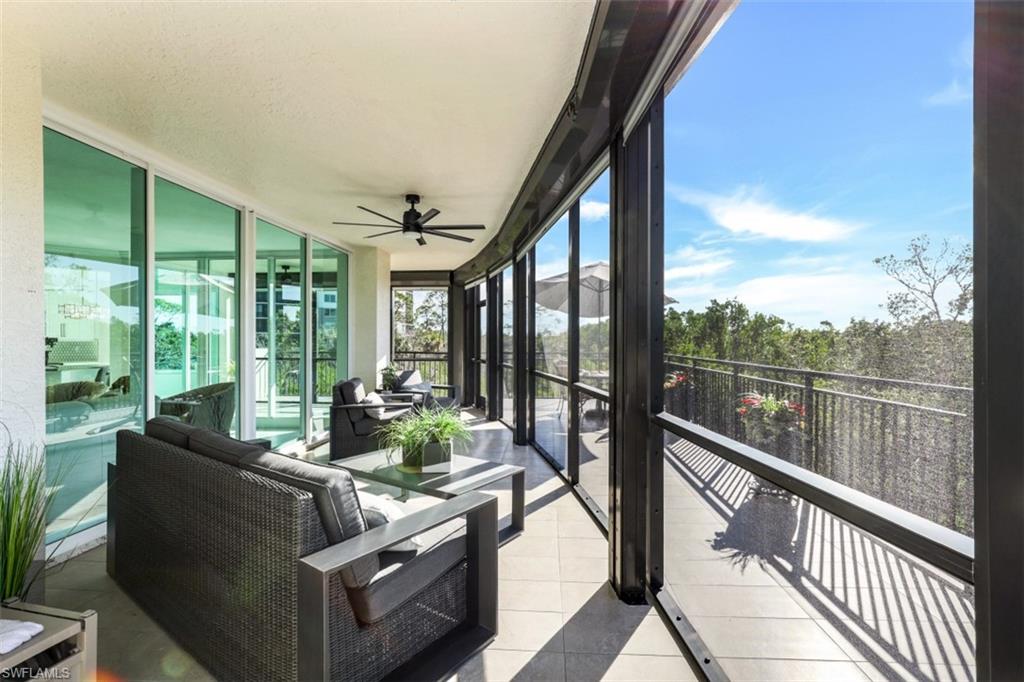 425 Cove Tower Drive, Unit 301 Naples, FL 34110 - Photo 29 of 43 a view of balcony with couch and chairs