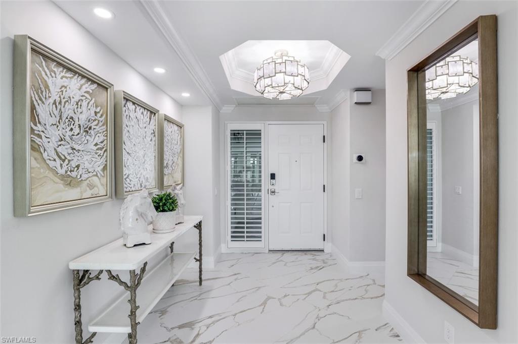 425 Cove Tower Drive, Unit 301 Naples, FL 34110 - Photo 3 of 43 a view of an entryway with a rug