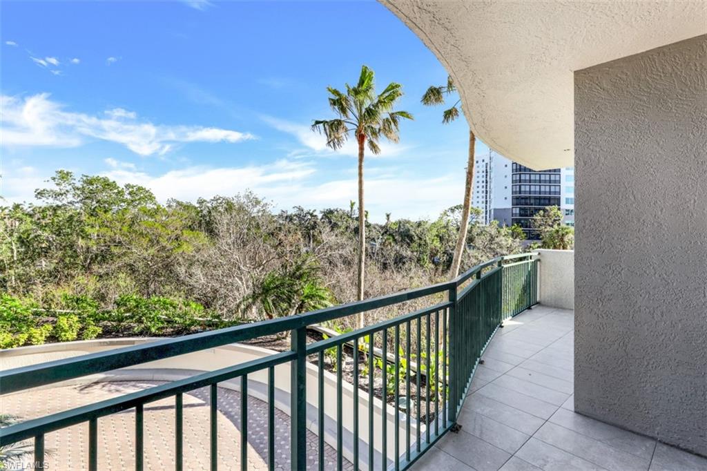 425 Cove Tower Drive, Unit 301 Naples, FL 34110 - Photo 34 of 43 a view of a balcony with a potted plant
