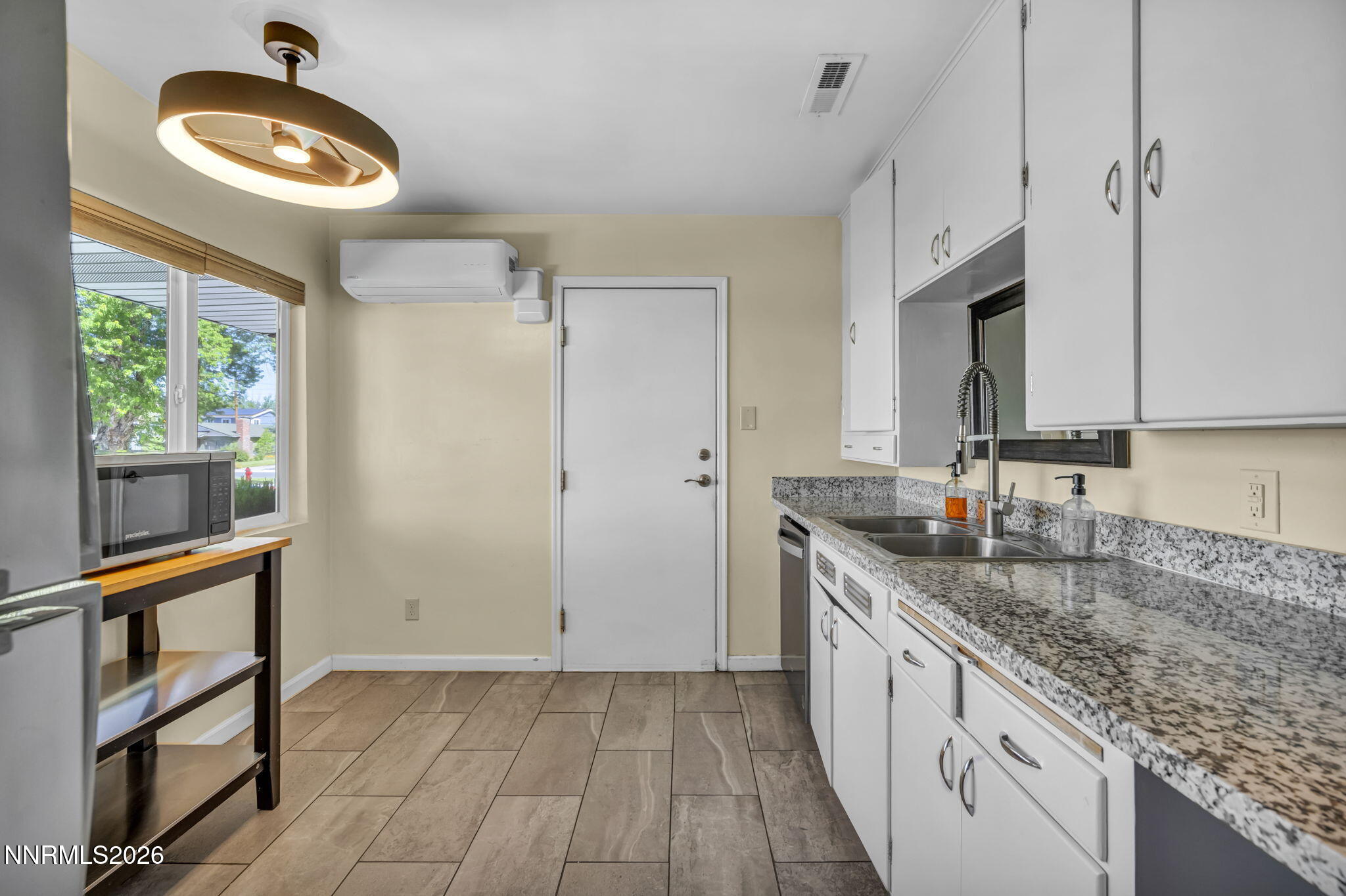 620 Belgrave Avenue Reno, NV 89502 - Photo 3 of 57 a kitchen with granite countertop cabinets a sink a window and stainless steel appliances
