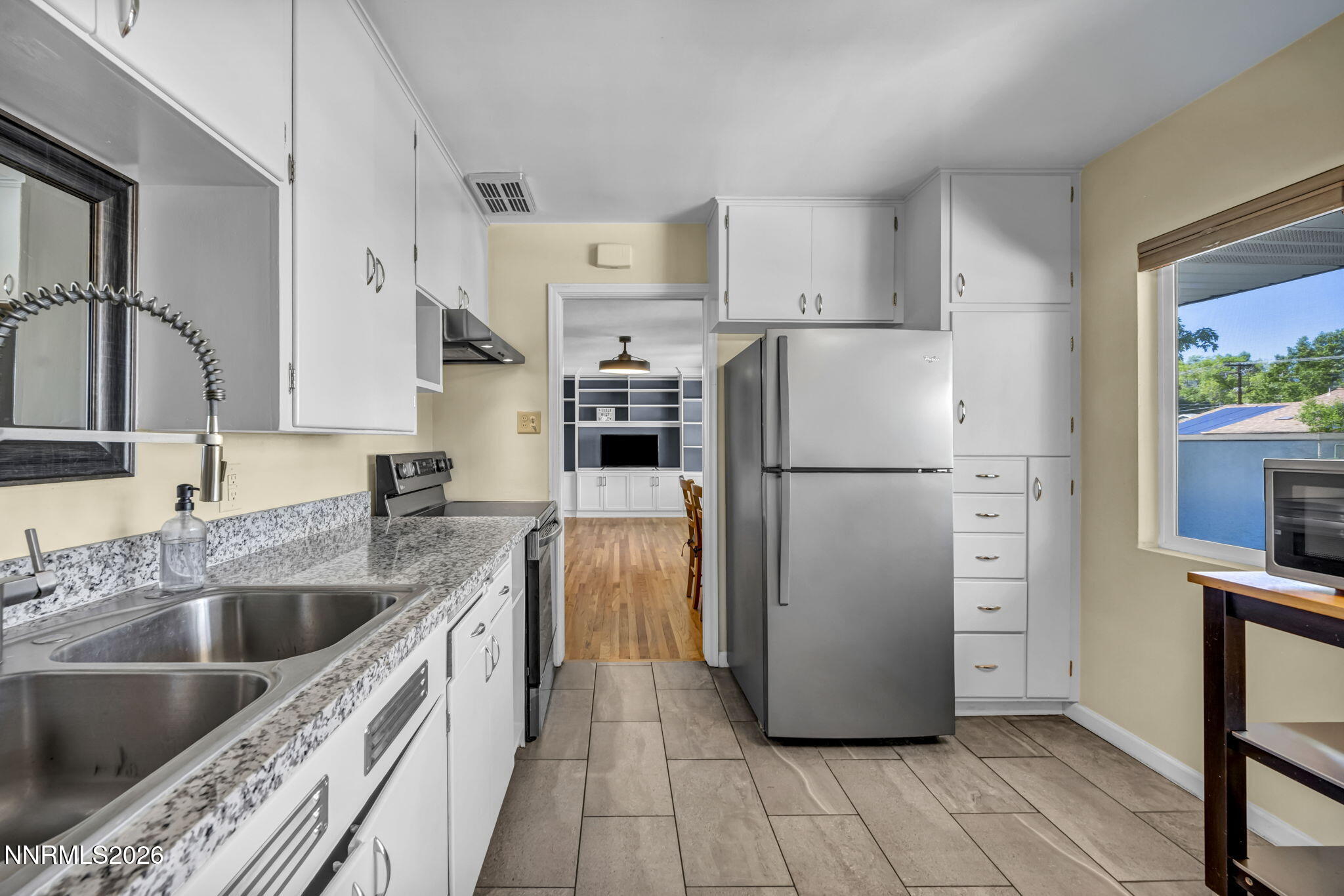 620 Belgrave Avenue Reno, NV 89502 - Photo 5 of 57 a kitchen with a refrigerator a sink and dishwasher with wooden floor