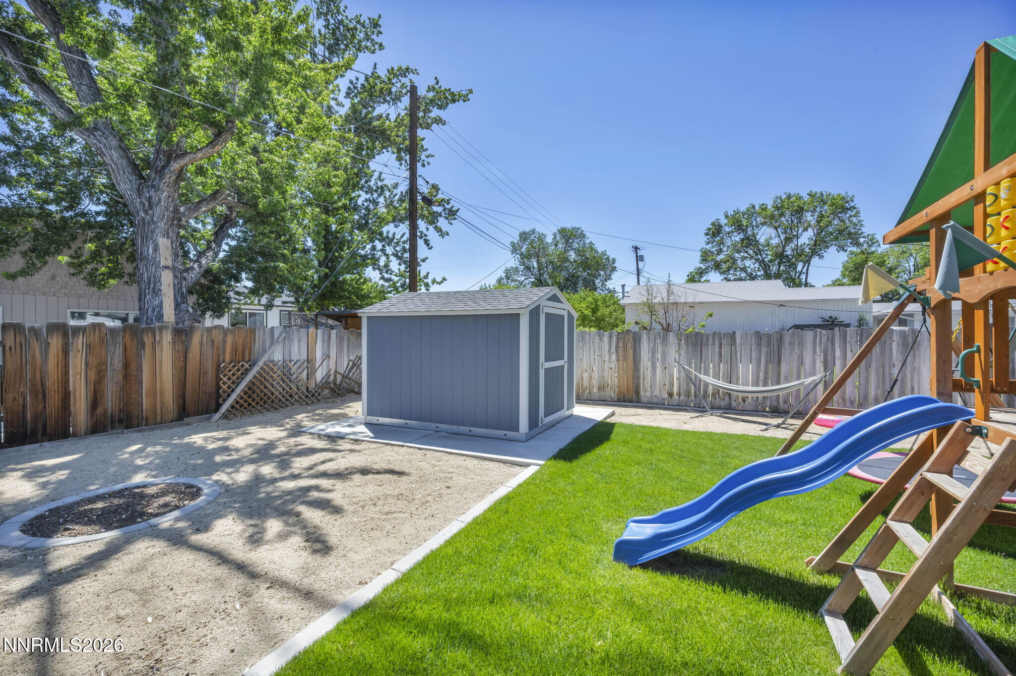 620 Belgrave Avenue Reno, NV 89502 - Photo 51 of 57 a view of a backyard with a slide and a tree