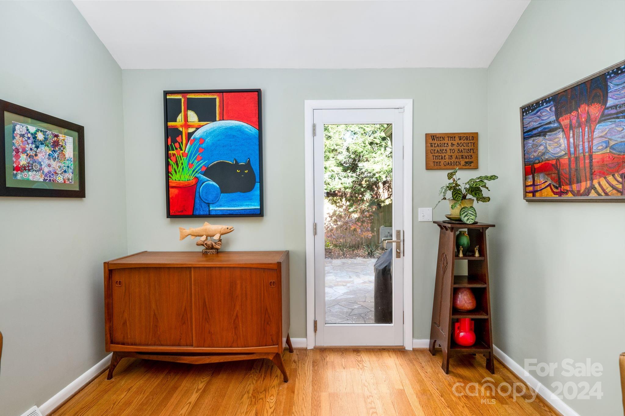 24 Maplewood Road Asheville, NC 28804 - Photo 14 of 38 a living room with painting on the wall and a wooden floor