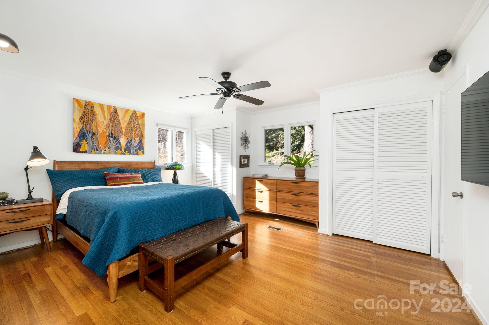 24 Maplewood Road Asheville, NC 28804 - Photo 18 of 38 a bedroom with a bed and wooden floor