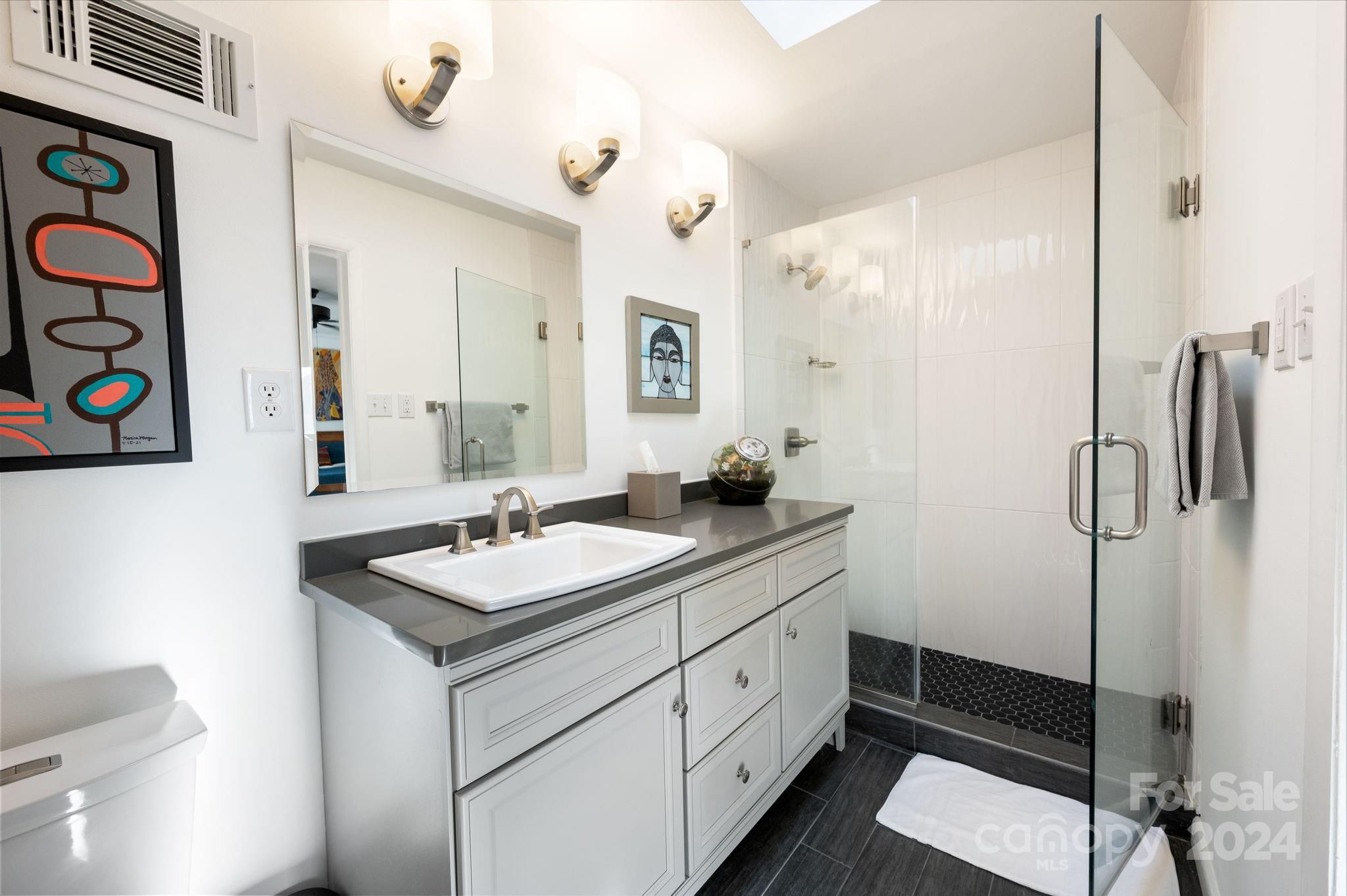24 Maplewood Road Asheville, NC 28804 - Photo 19 of 38 a bathroom with a sink vanity granite and a mirror