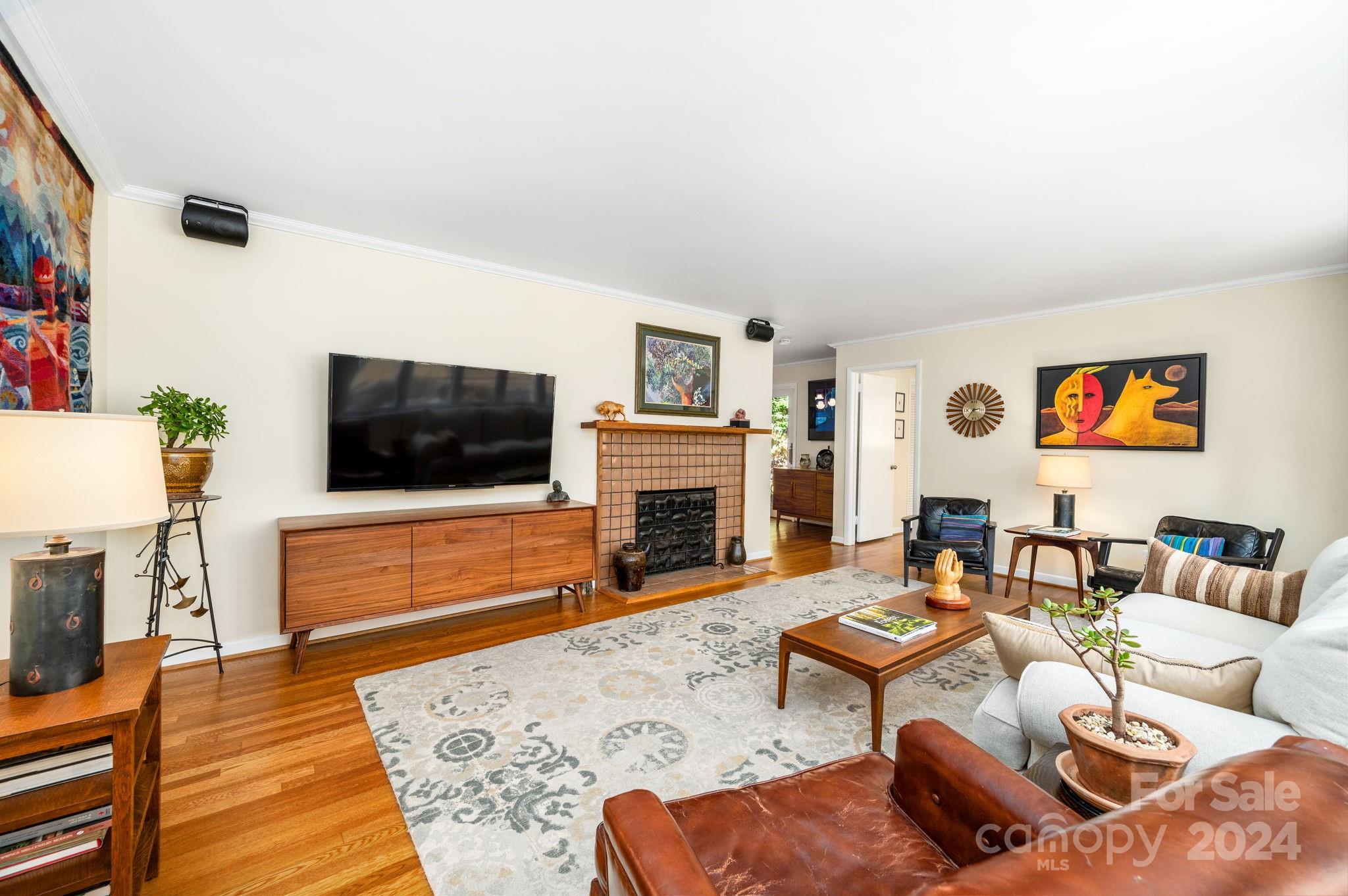 24 Maplewood Road Asheville, NC 28804 - Photo 7 of 38 a living room with furniture a flat screen tv and a fireplace