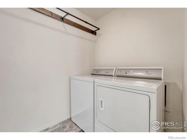 a view of an empty room with closet and a chandelier fan