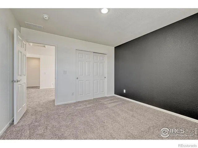 an empty room with closet area