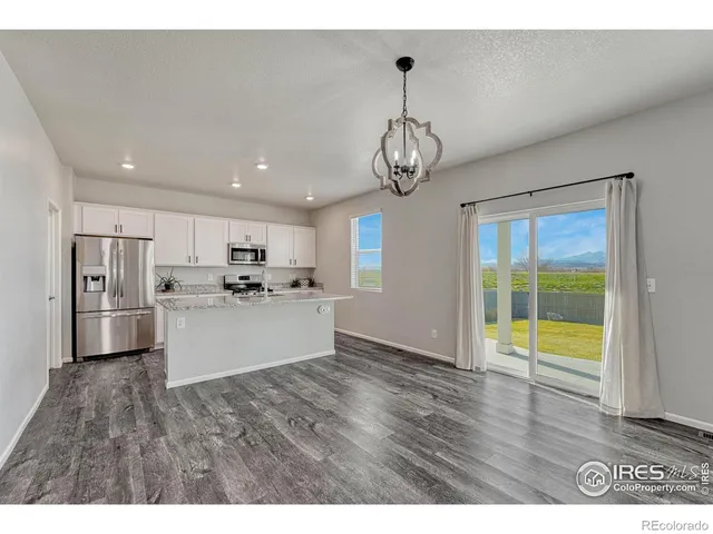 a view of a kitchen with a sink stainless steel appliances and cabinets