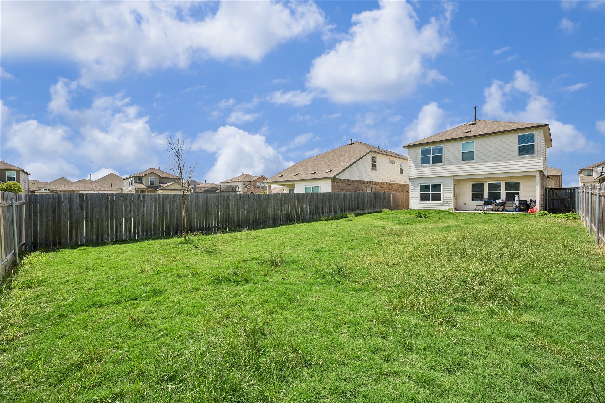 217 Canley Loop Hutto, TX 78634 - Photo 35 of 36 A spacious, grassy backyard provides ample room for outdoor activities and future landscaping dreams.