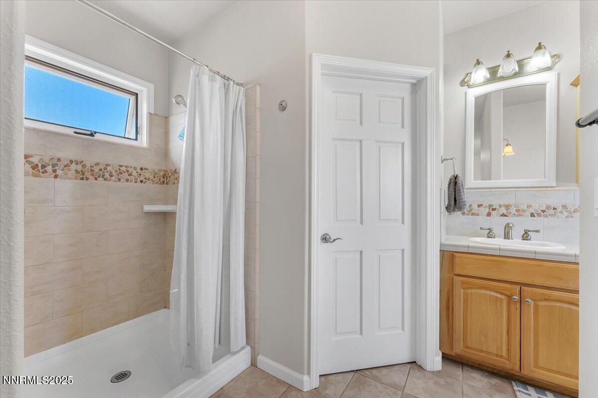 400 Britt Road Reno, NV 89508 - Photo 18 of 53 a bathroom with a shower a sink and a mirror