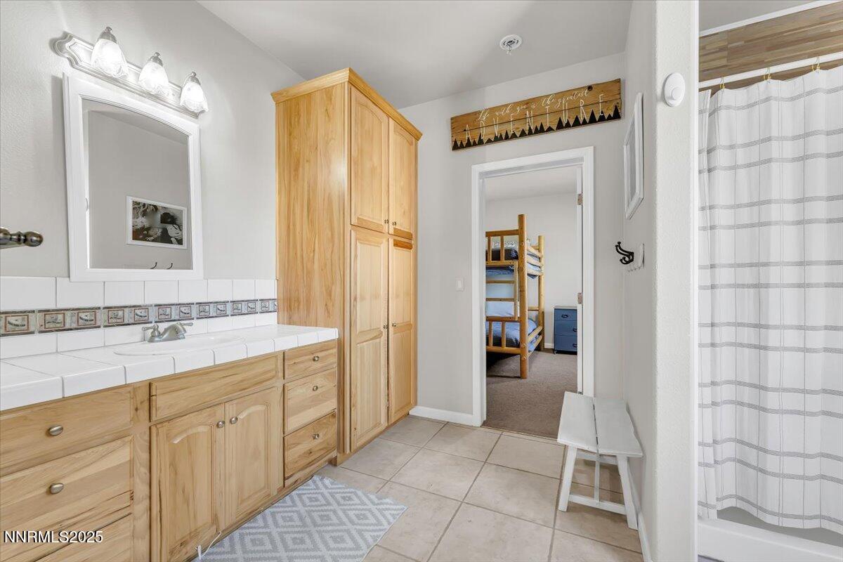 400 Britt Road Reno, NV 89508 - Photo 23 of 53 a spacious bathroom with a double vanity sink and a mirror