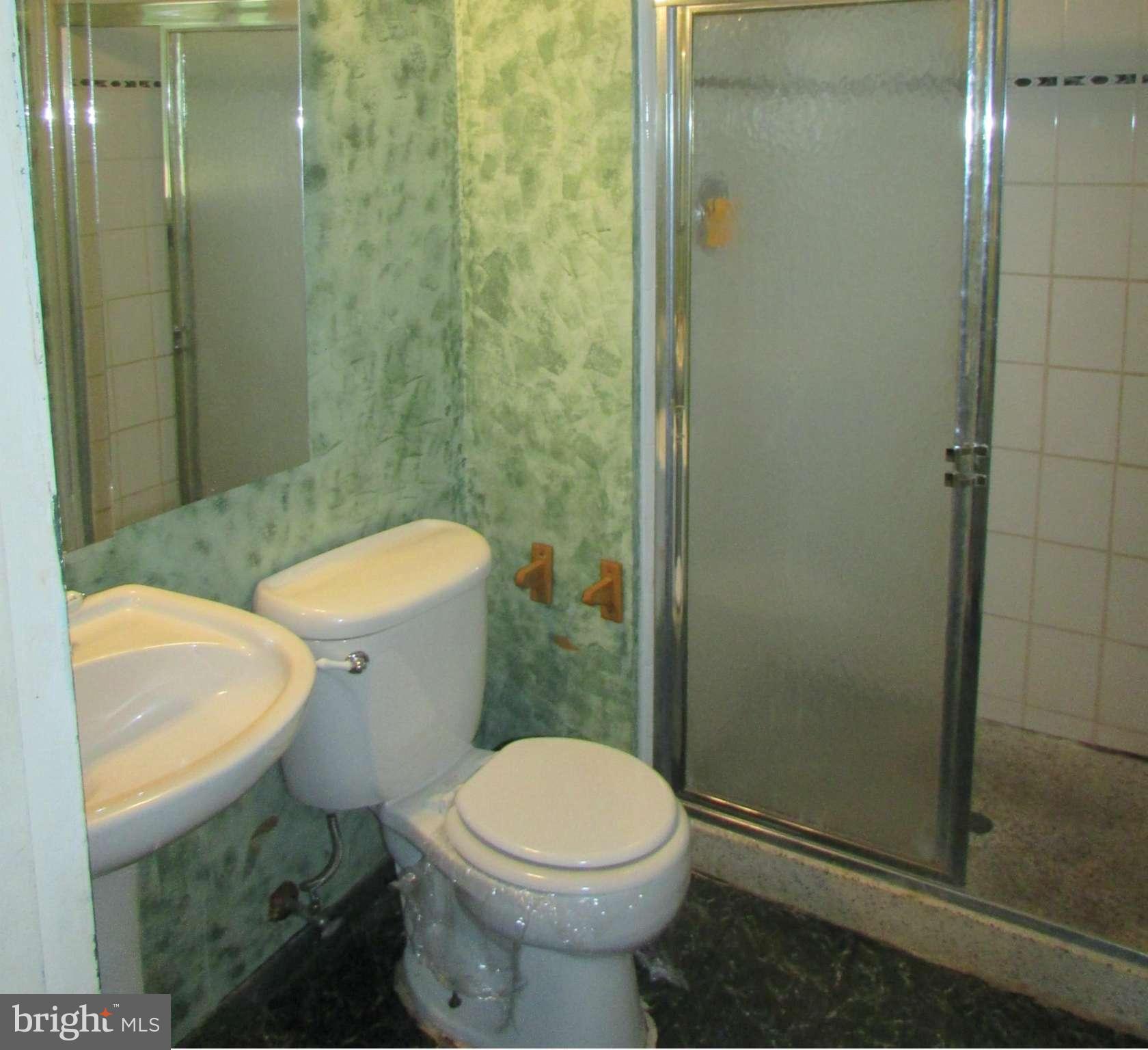 4614 Talman Road Pikesville, MD 21208 - Photo 14 of 27 a white toilet sitting next to a bathroom sink
