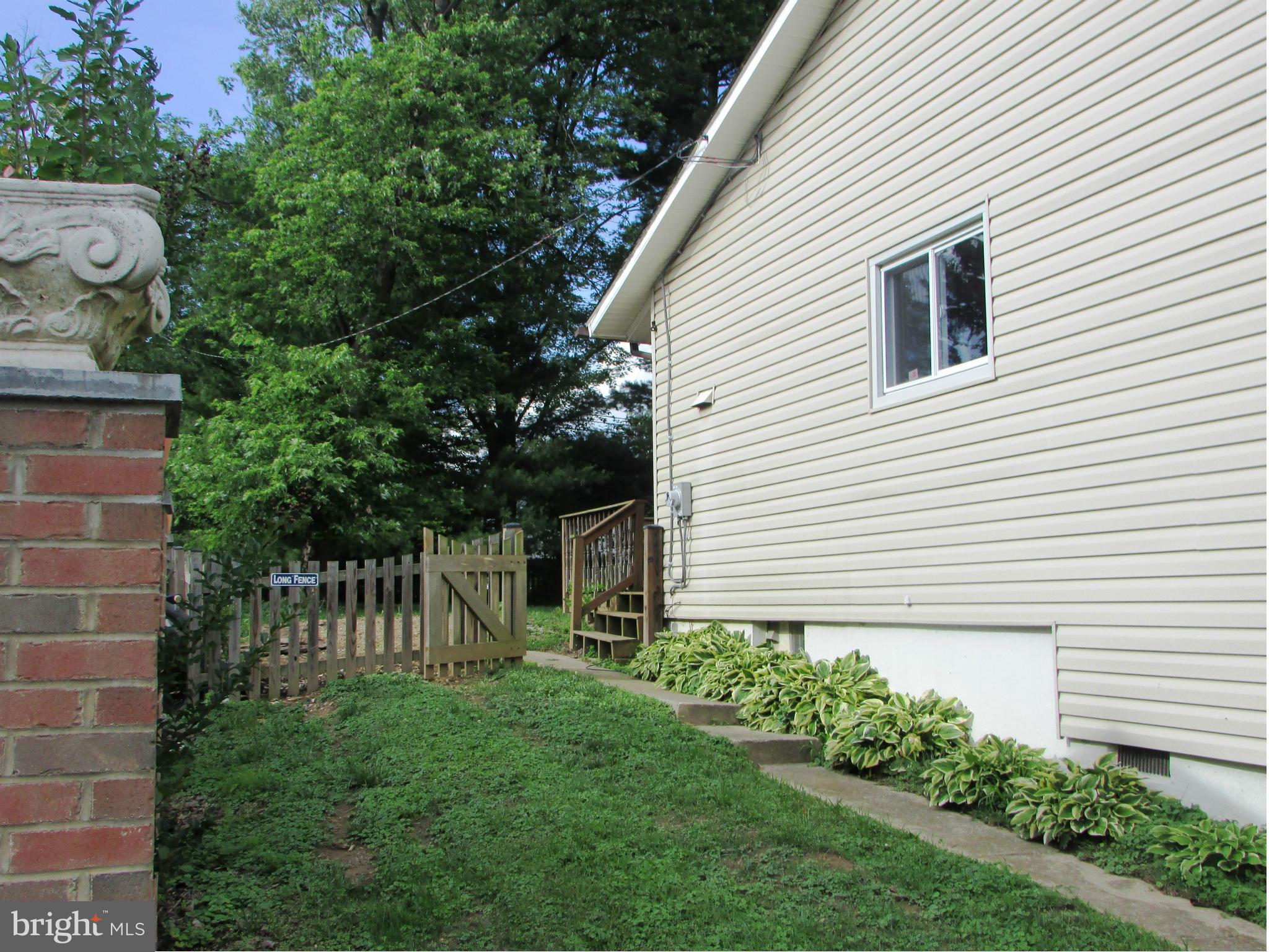 4614 Talman Road Pikesville, MD 21208 - Photo 3 of 27 a view of a house with a yard and a garden