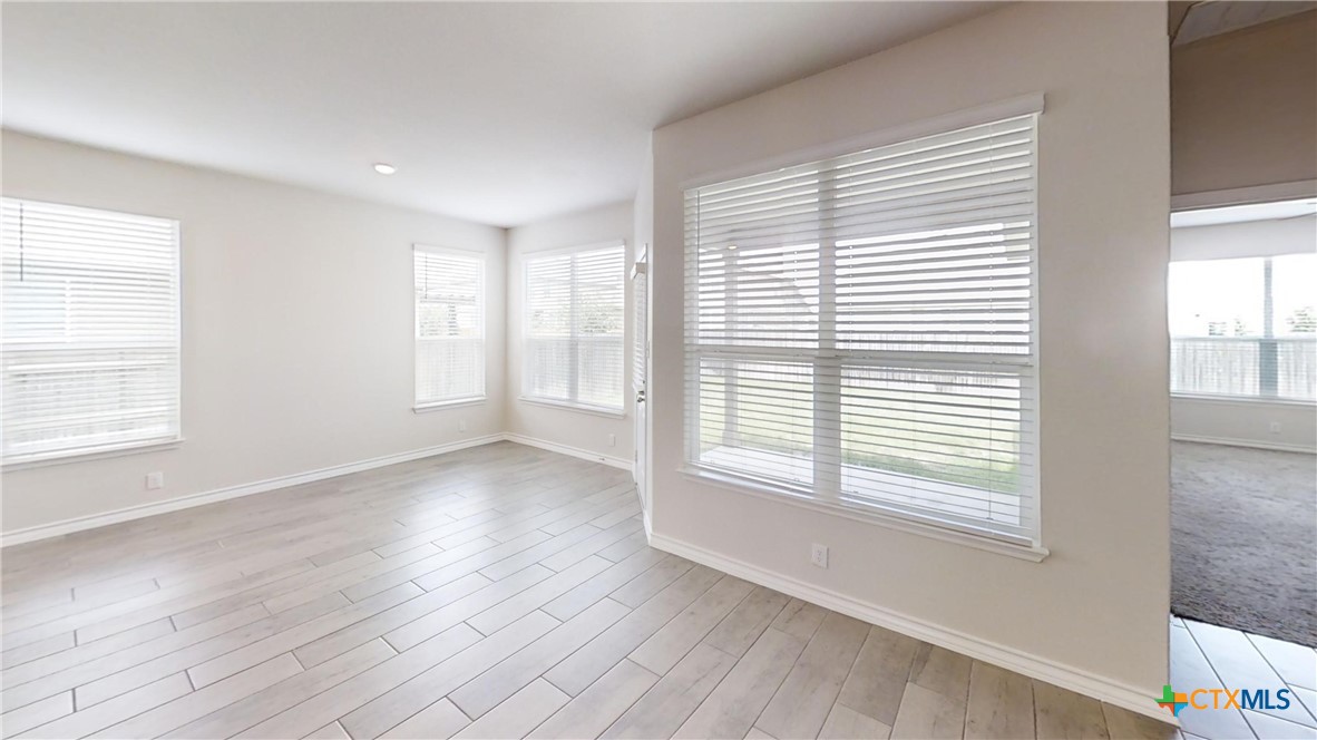 602 Steele Shallows Cibolo, TX 78108 - Photo 2 of 10 a view of an empty room with wooden floor and a window