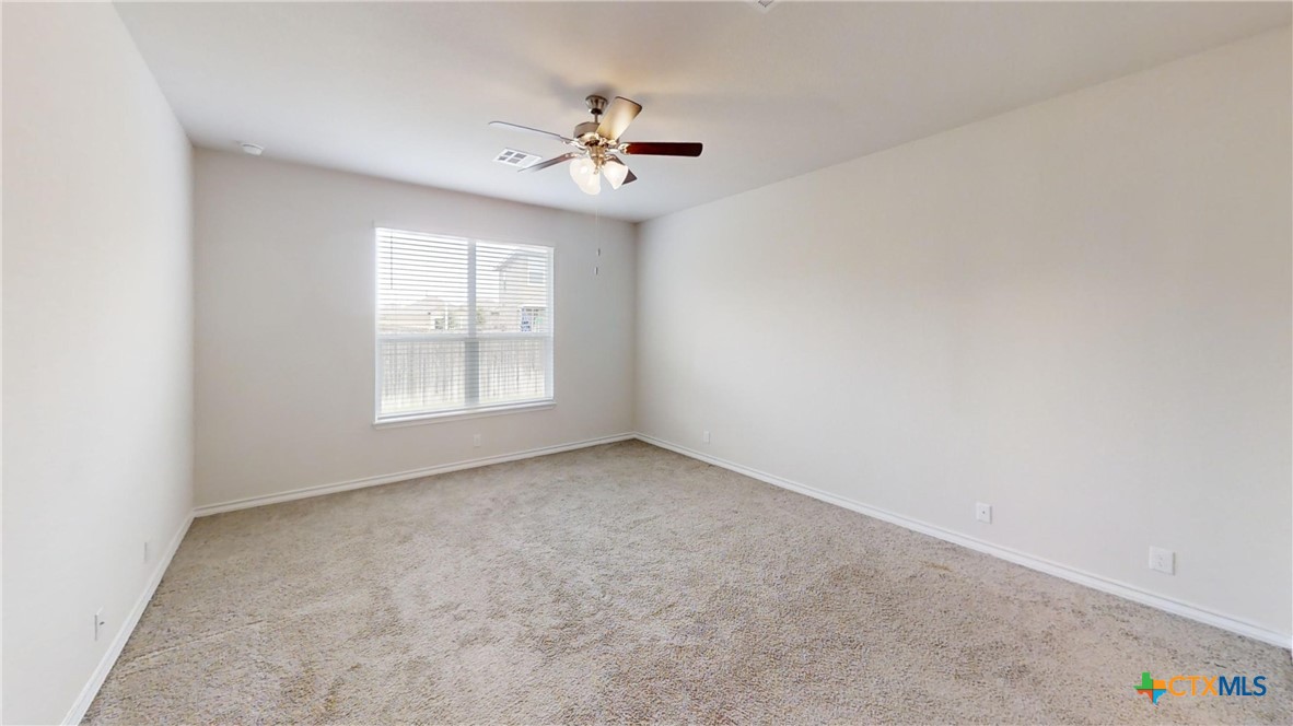 602 Steele Shallows Cibolo, TX 78108 - Photo 7 of 10 an empty room with windows and chandelier fan