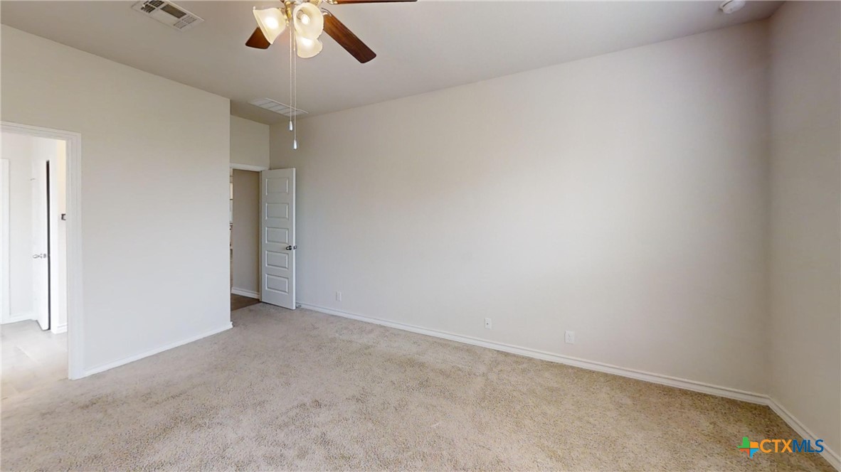 602 Steele Shallows Cibolo, TX 78108 - Photo 8 of 10 an empty room with a ceiling fan and carpet