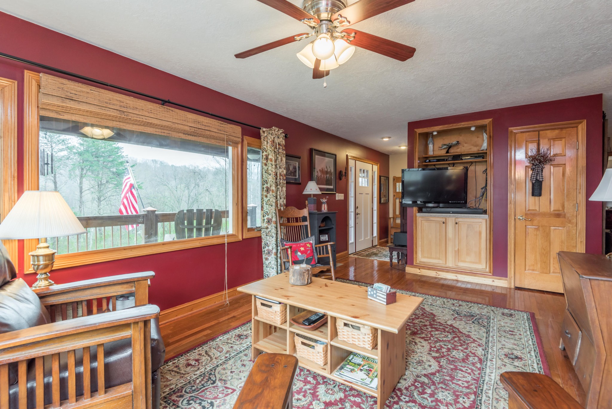 1521 Blockhouse Road Maryville, TN 37803 - Photo 6 of 40 a living room with furniture a flat screen tv and a floor to ceiling window
