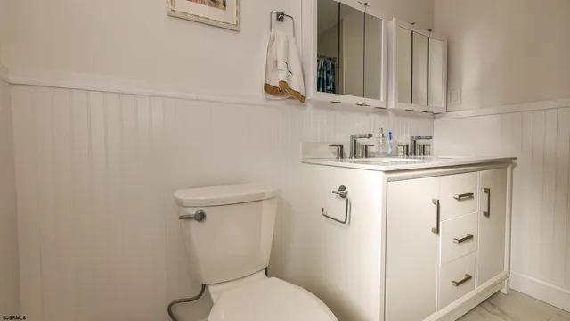 a white toilet sitting next to a bathroom sink