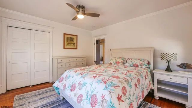 a bedroom with a large bed and a chandelier