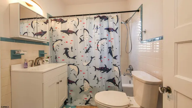 a white toilet sitting next to a bathroom sink