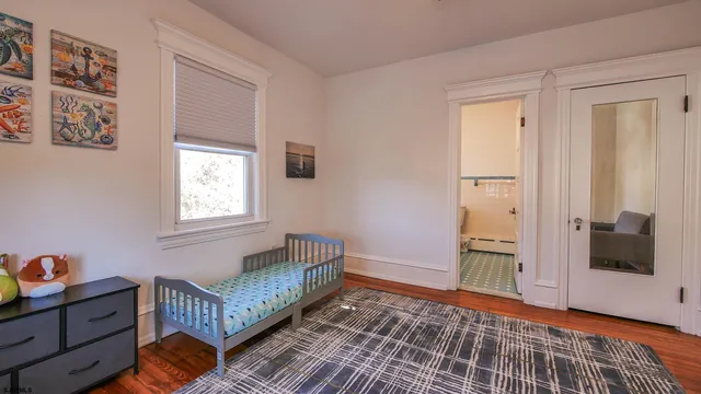 a bedroom with furniture and a window