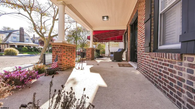 a view of a patio with a table and chairs and potted plants