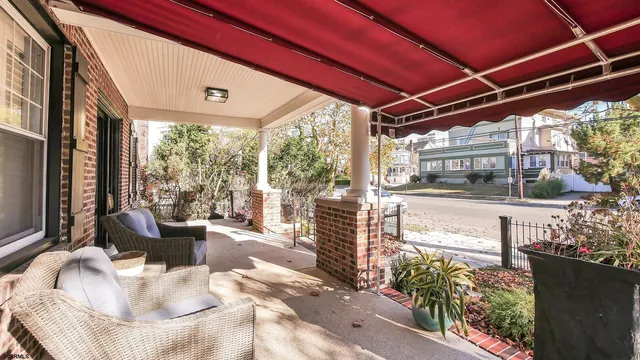 a building outdoor space with patio furniture and potted plants