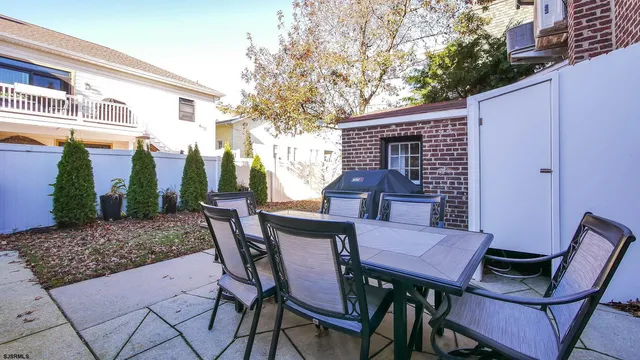 a view of a patio with a table and chairs