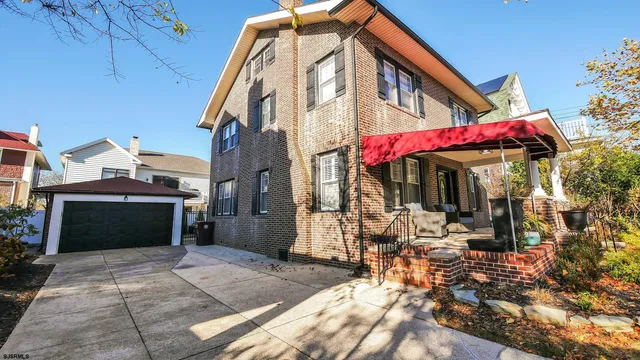 a view of a house with yard and sitting area