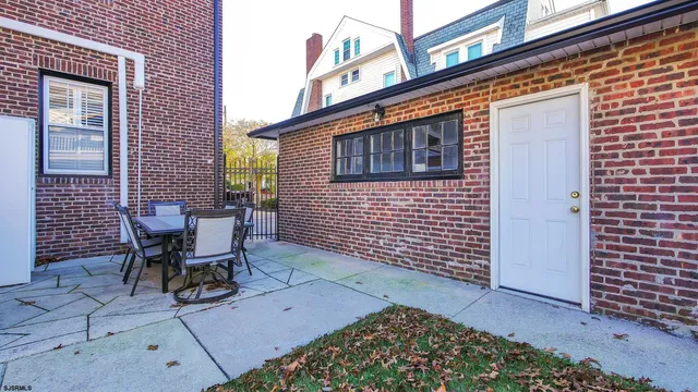 a view of a patio with a table and chairs and potted plants