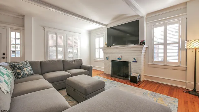 a living room with furniture fireplace and flat screen tv