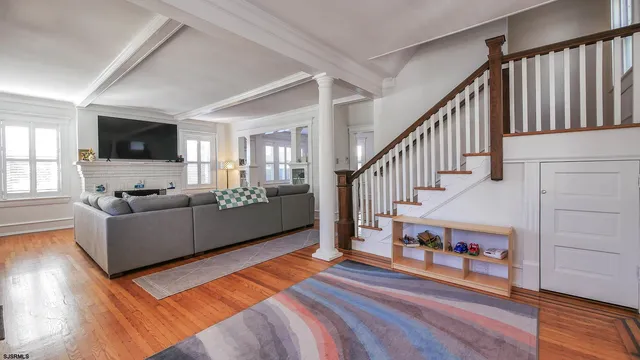 a living room with furniture and a flat screen tv