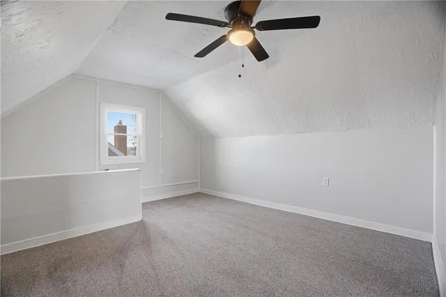 an empty room with closet and windows
