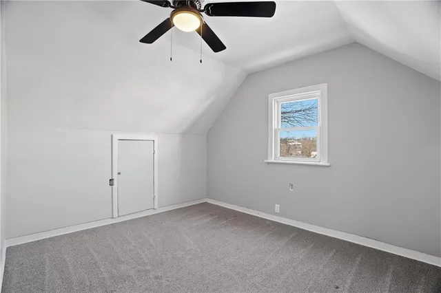 an empty room with chandelier fan