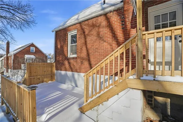 a view of a balcony with wooden floor and fence