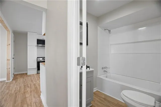 a bathroom with a toilet and a shower