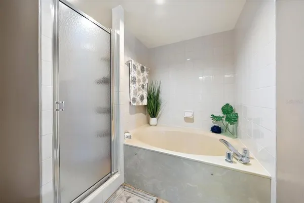 a bathroom with a bathtub and shower